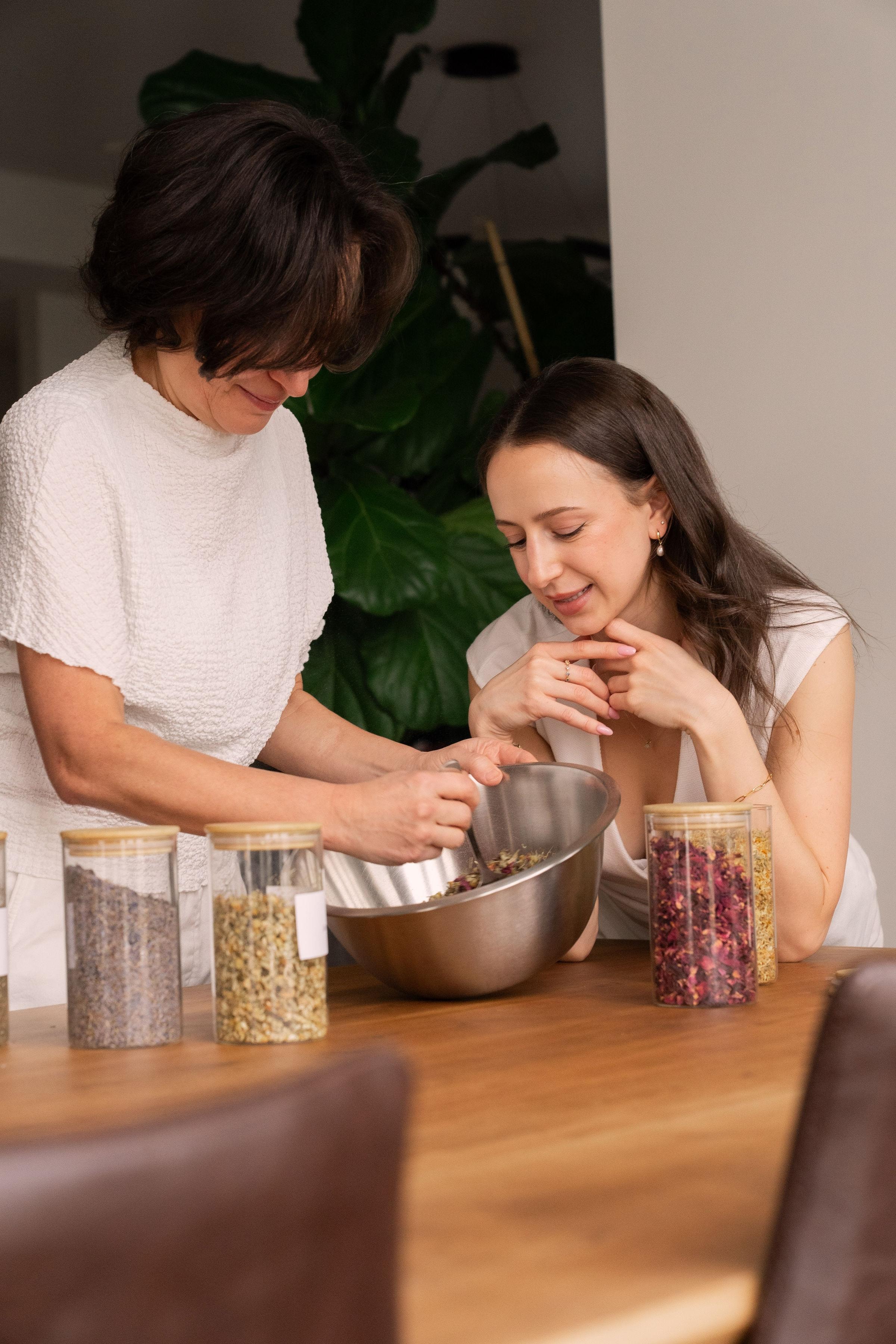 Marina and Estie preparing a botanical blend together