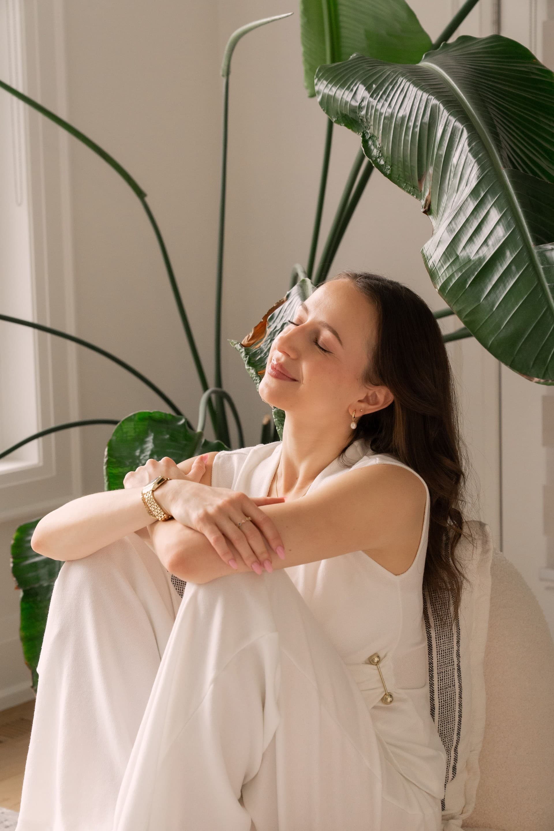 Estie seated indoors during a quiet breathing practice